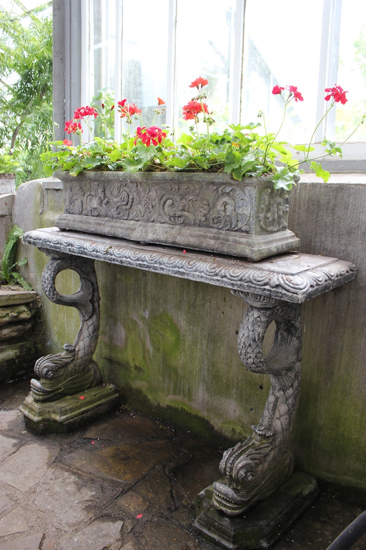 antique table and red geraniums