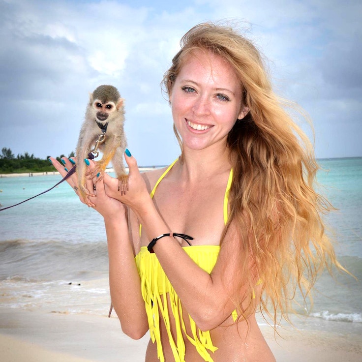girl in bikini with a spider monkey