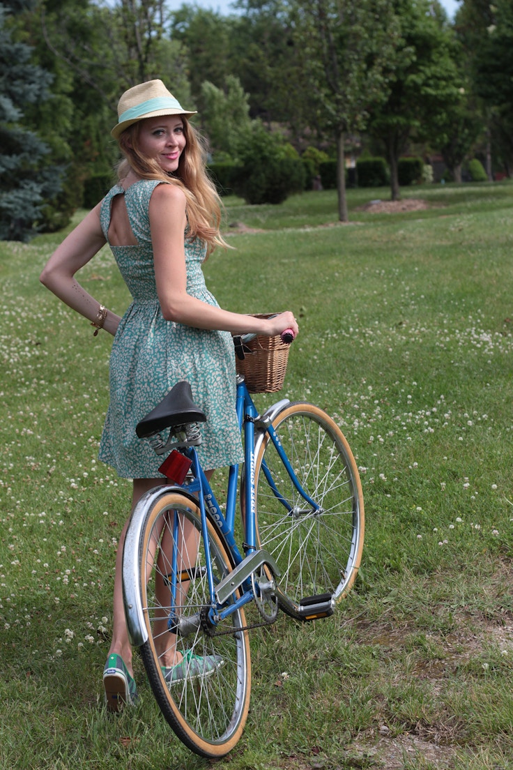 girl in green dress with bike