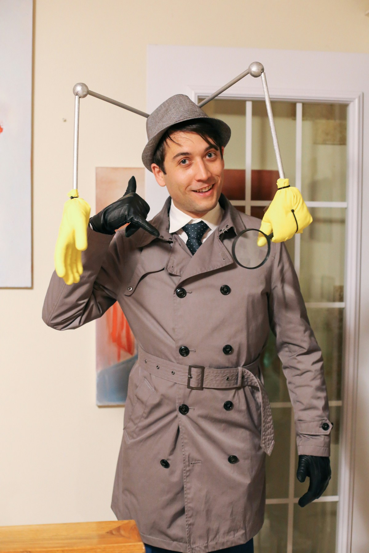 Inspector Gadget DIY Halloween Costume: to make this Inspector Gadget hat you need a fedora, wooden dowels, styrofoam balls, a magnifying glass and rubber gloves.