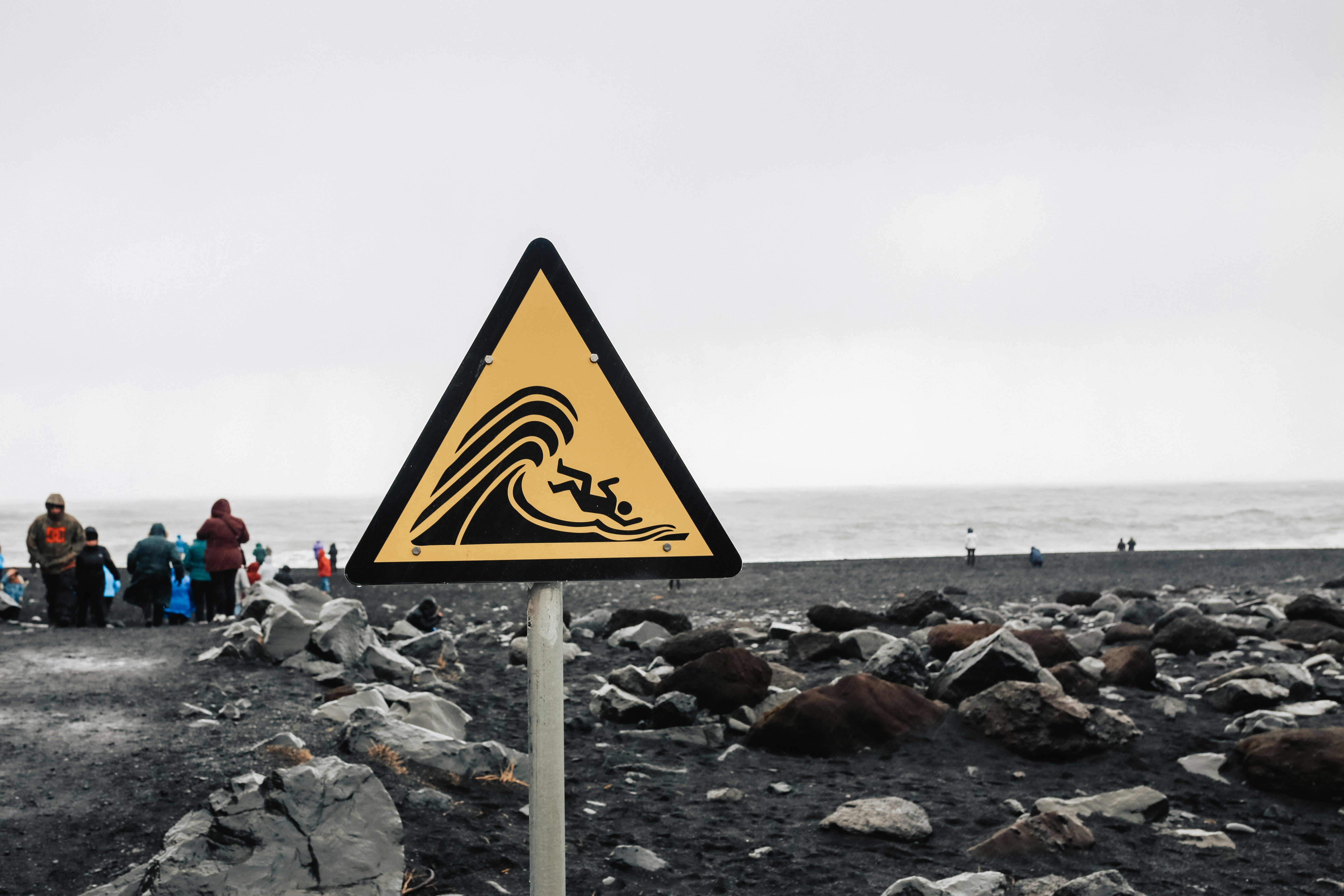 The warning sign at Reynisfjara Beach warning visitors not to stand too close to the edge because of "sneaker waves" that can drag you (and your car) into the Atlantic Ocean.