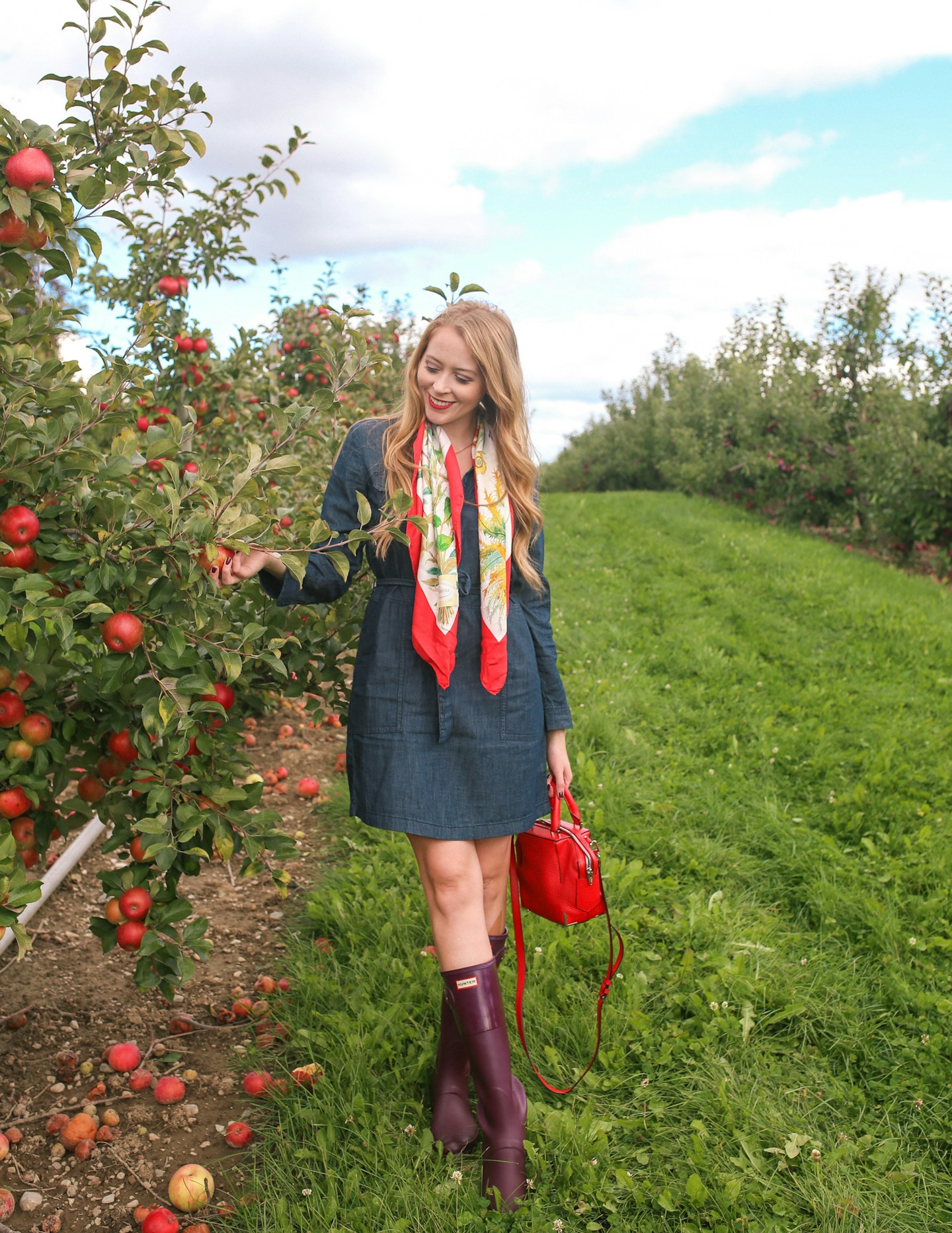What to wear to go apple picking near Toronto: a denim dress, tall Hunter boots and a vintage Gucci silk scarf is a chic fall outfit idea.