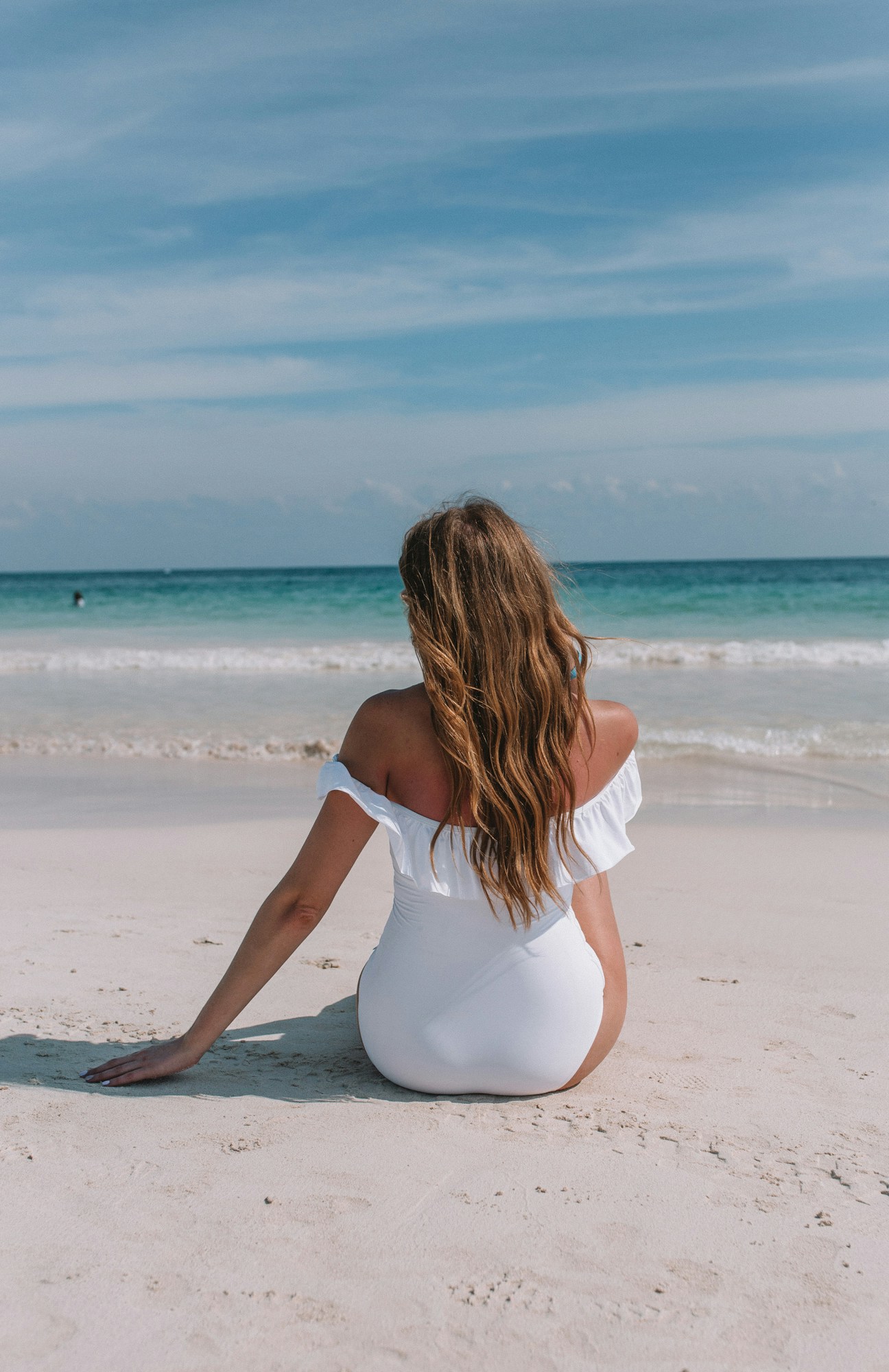 Tulum Playa Paraiso Beach - I wore a white off the shoulder one piece swimsuit from La Vie en Rose to relax on the white sandy beach of Tulum, Mexico.