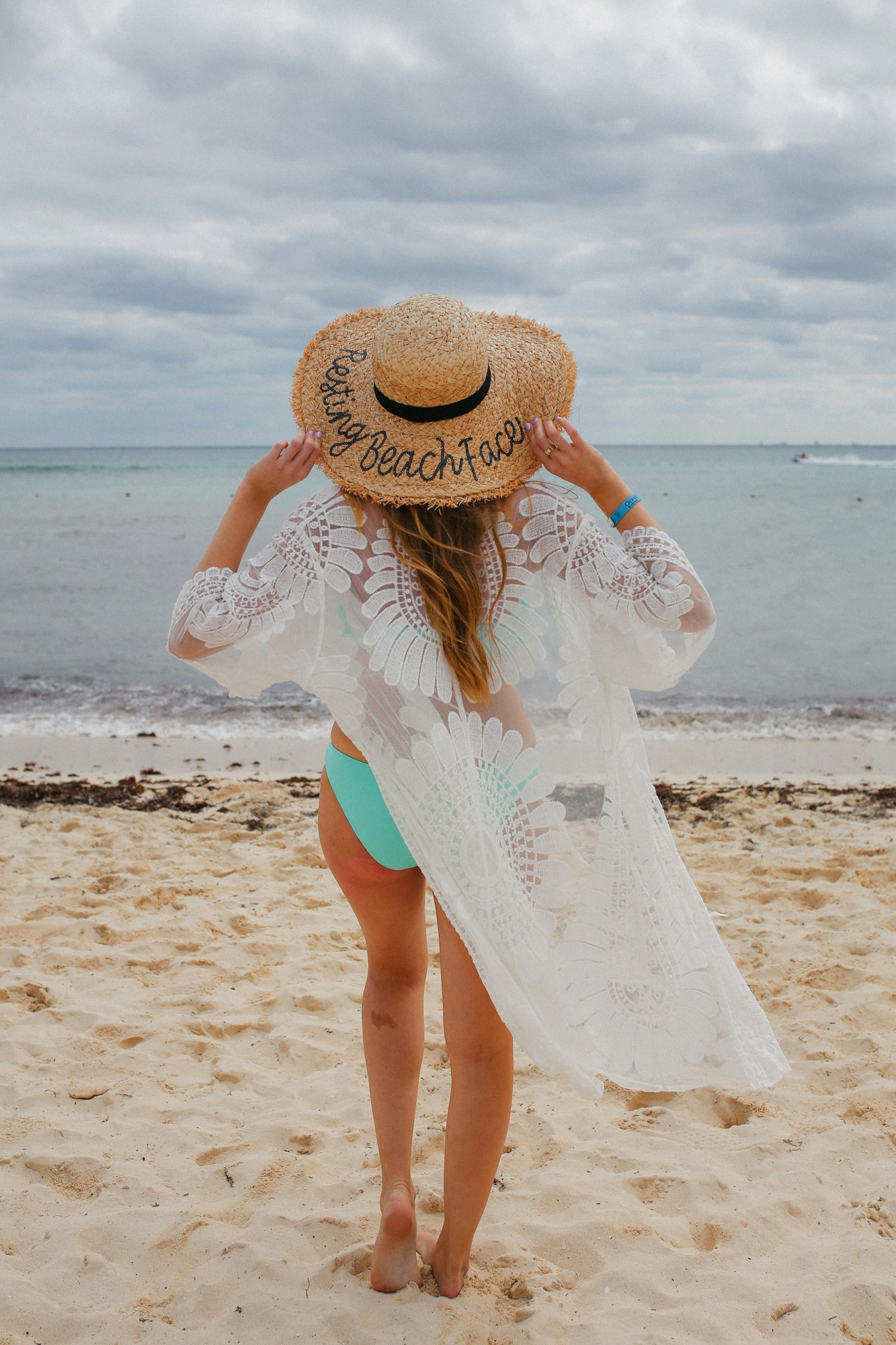 This white lace beach coverup from Amazon is a must-buy! I love how inexpensive it is and it's so chic! Also wearing a Resting Beach Face sunhat for a cheeky resort look.
