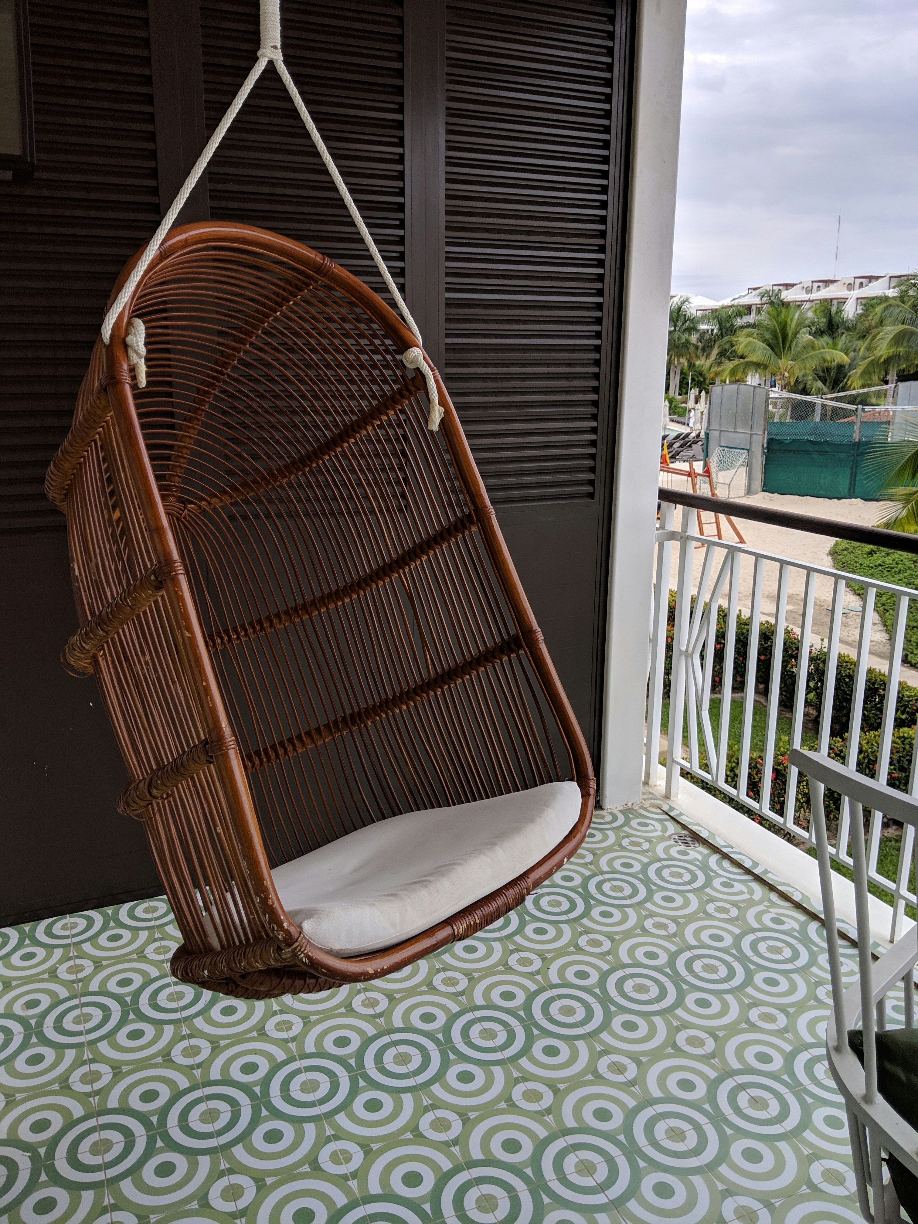 Hanging rattan egg chair on a balcony - a gorgeous retreat at Ocean Riviera Paradise
