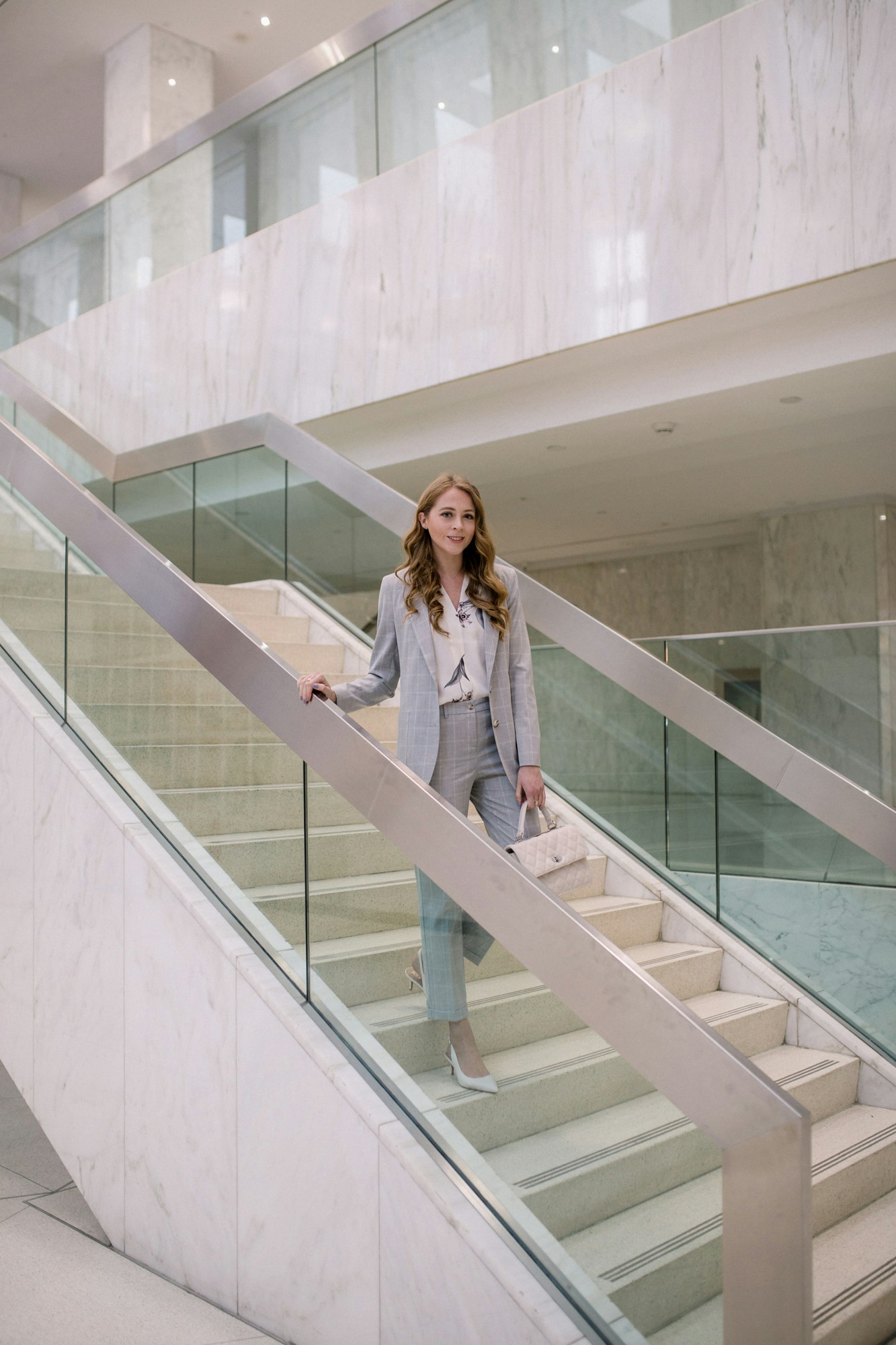 Chic grey suit for corporate work environment. Dressing for the office can be a challenge, but a sleek classic suit in a modern cut is easy to wear. This grey plaid suit from Le Chateau is easy to dress up or down. 