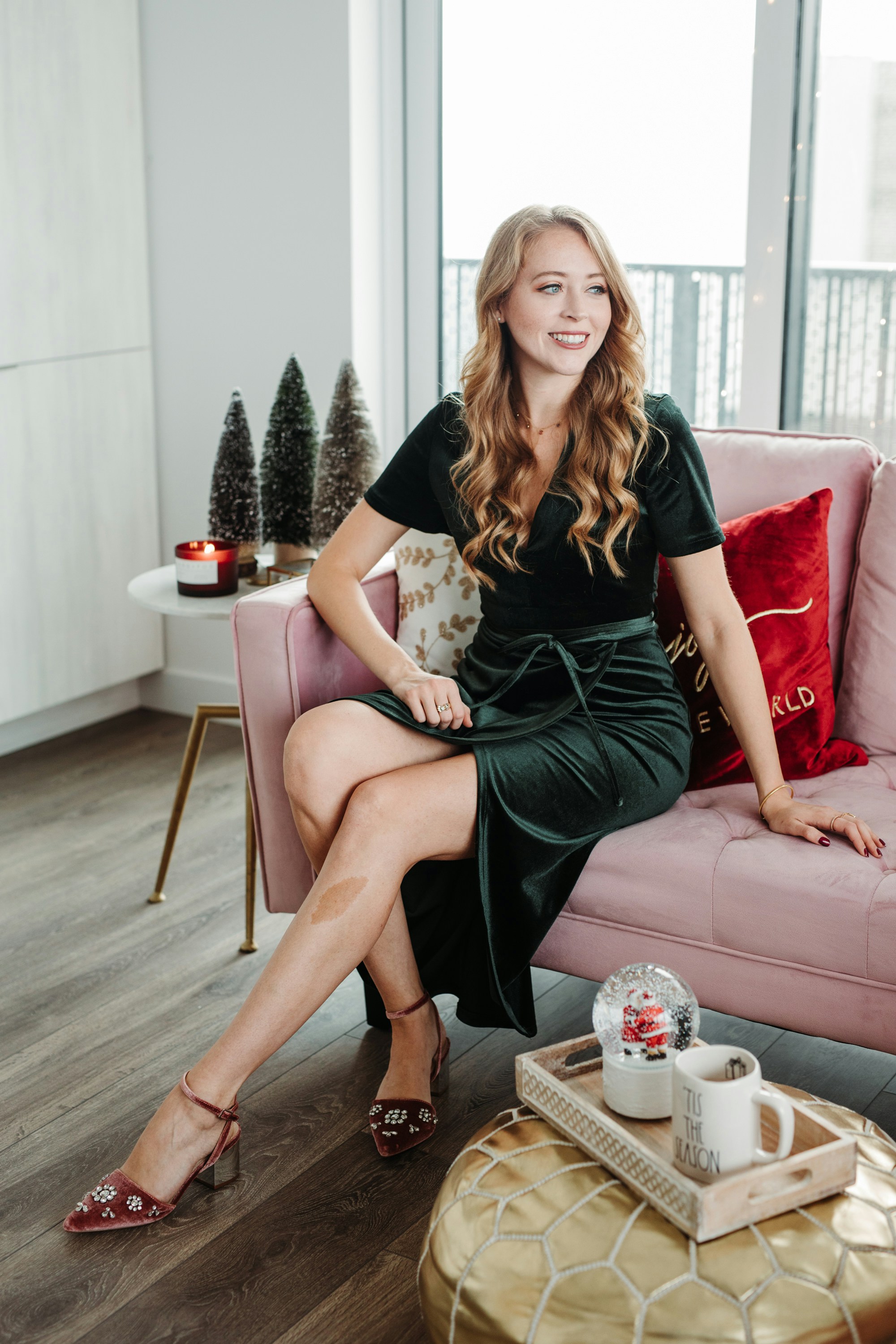 Condo Christmas Decor: gold, pink velvet couch, red velvet cushions, bottlebrush trees - home decorating ideas for the Holidays with HomeSense Canada.