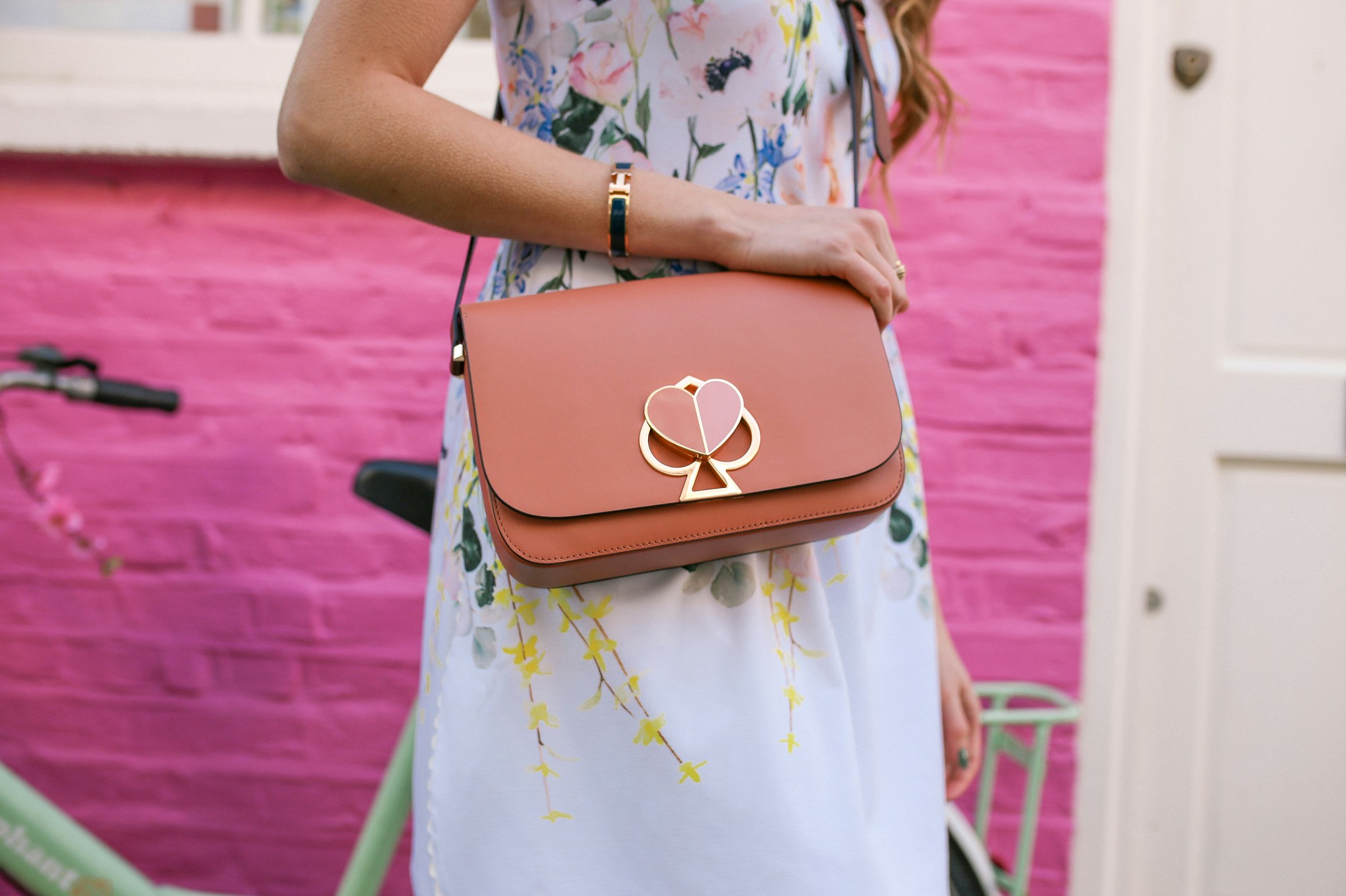 The Kate Spade Nikola bag is the perfect cute bag featuring a heart-shaped clasp.