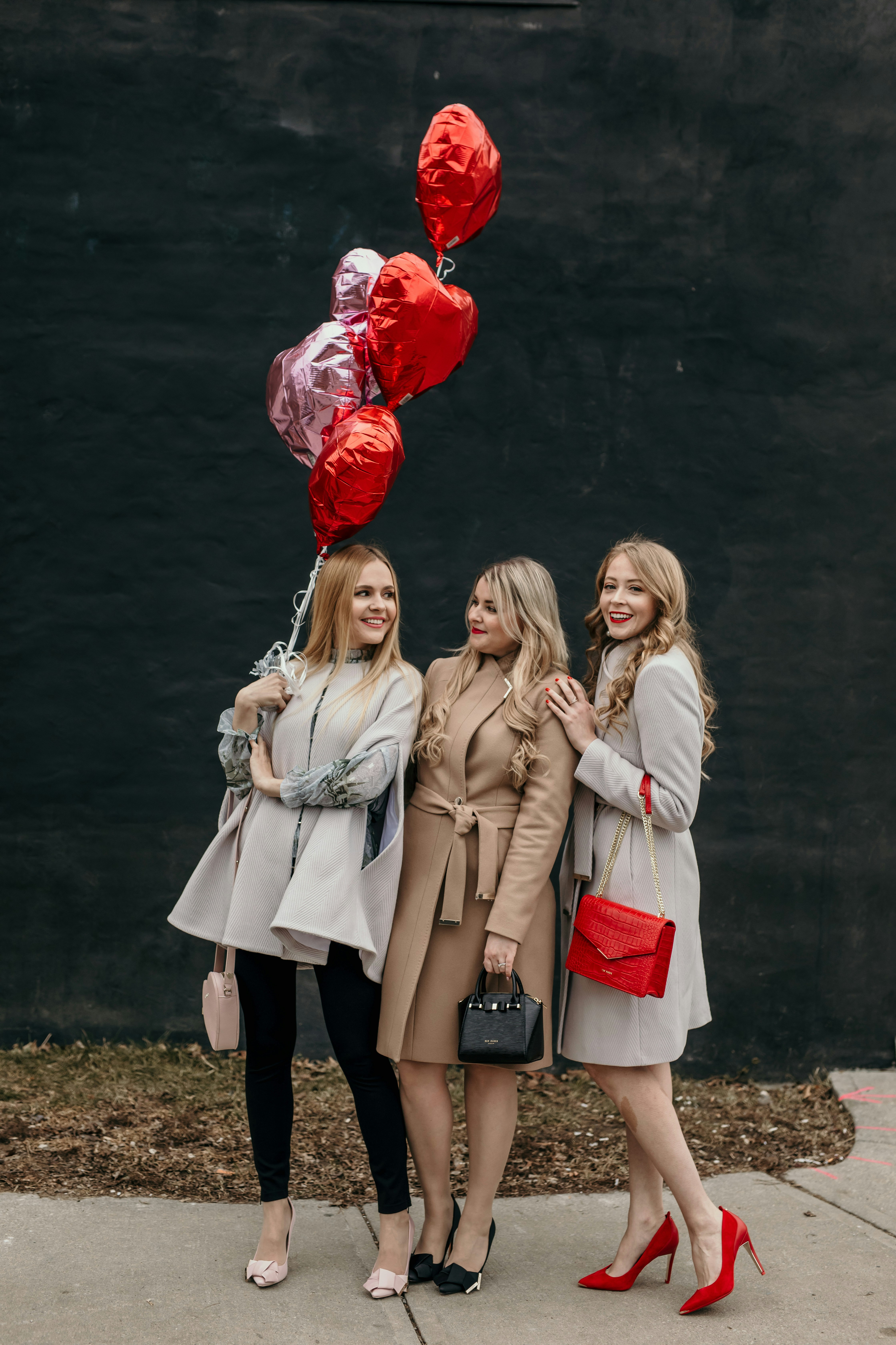 Ted Baker Galentine's Day Looks: wool coats and capes, heart handbags, pops of red and elegant dresses.