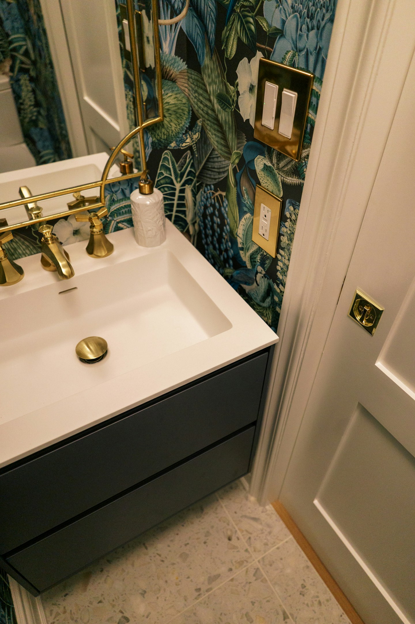 Adding brass fixtures to a bathroom elevates the look - don't forget the matching brass outlet and switchplates too.
